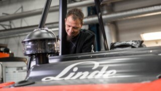 Servicetekniker arbetar med en Lindertruck i en verkstad. Servicetekniker arbetar med en Lindertruck i en verkstad.